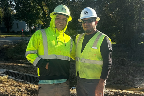 Construction worker holding blank white board home-about